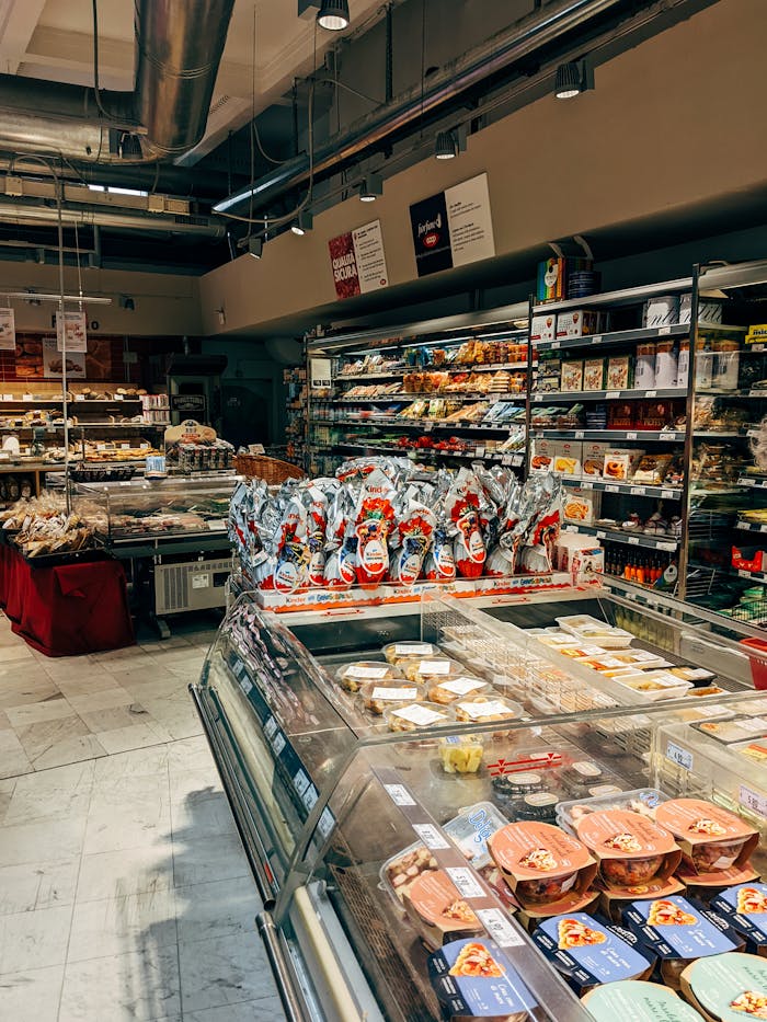 A well-organized supermarket aisle featuring diverse food items and grocery products.