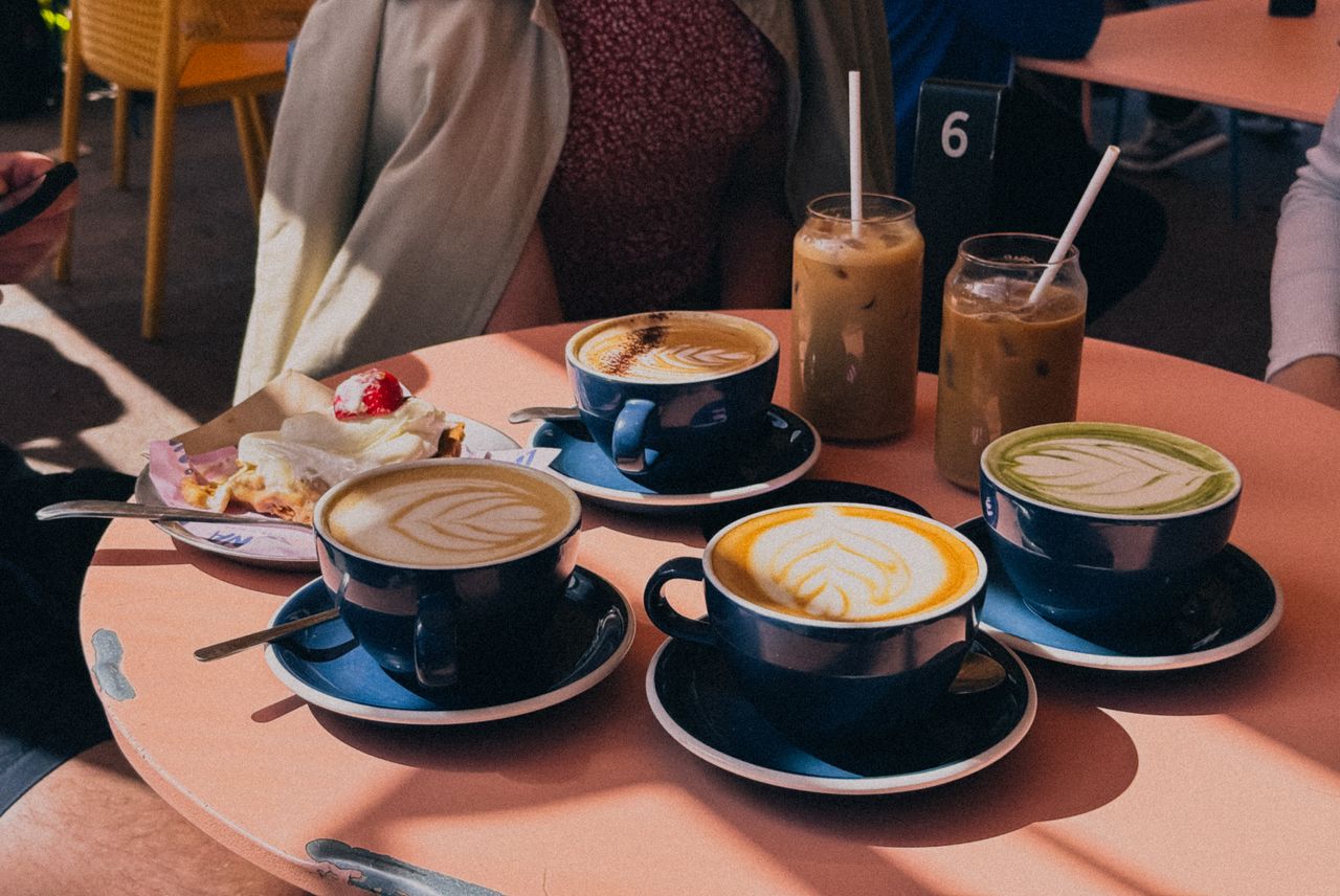 Crafting Captivating Headlines: Your awesome post title goes here Outdoor café setting with lattes and desserts, perfect for a cozy brunch or meeting with friends.